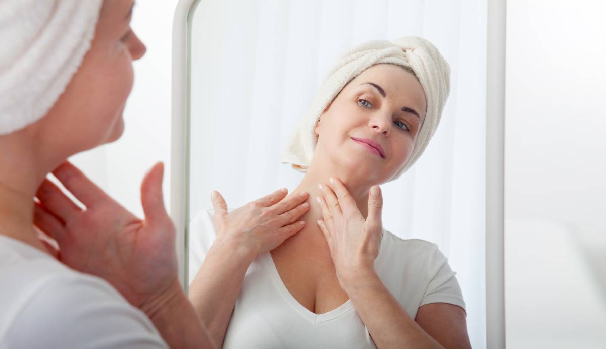 Woman using proper skincare to promote healing after a neck lift.