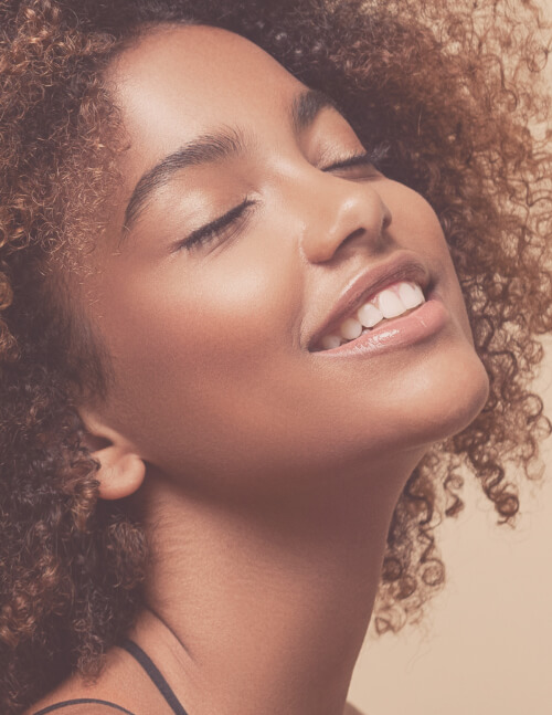 beautiful smiling woman with afro curls hairstyle